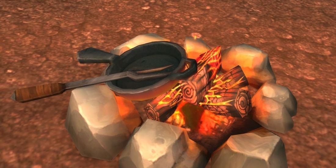 Uma frigideira e um garfo colocados em uma fogueira em World of Warcraft